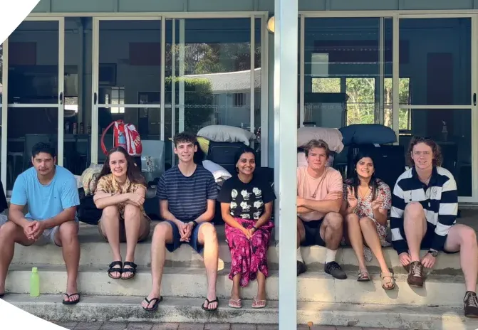 Group in front of the Dining Hall at Debrief