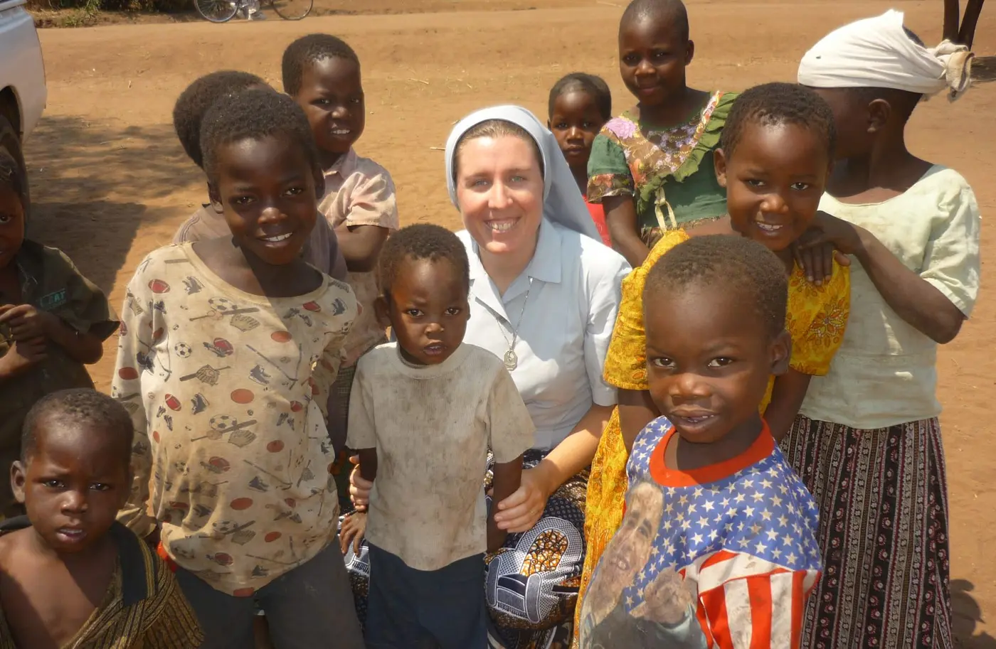 A sister with children outdoors on a dirt road