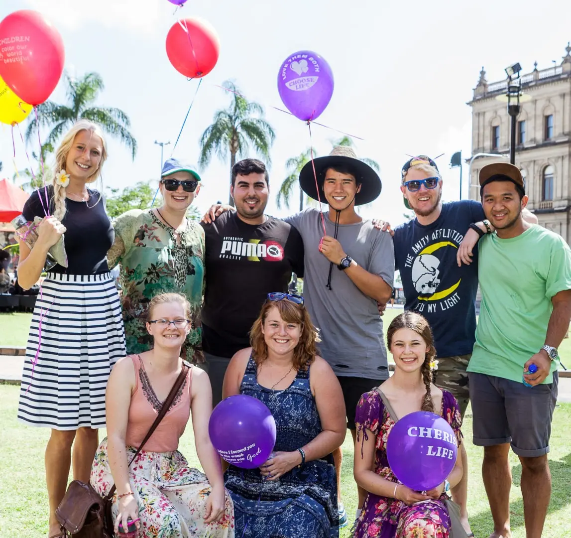 Young people with balloons outdoors