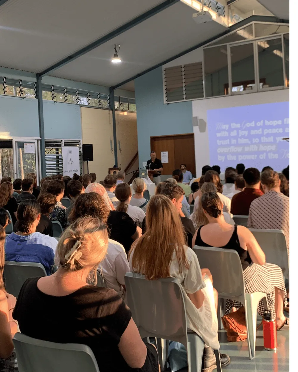 A full hall listening, with song lyrics on the screen